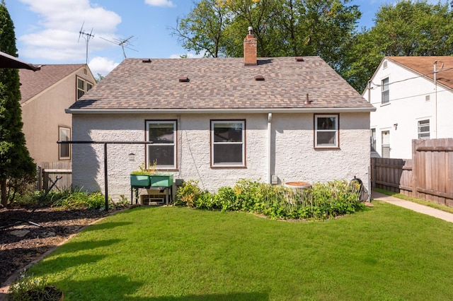 rear view of house with a yard