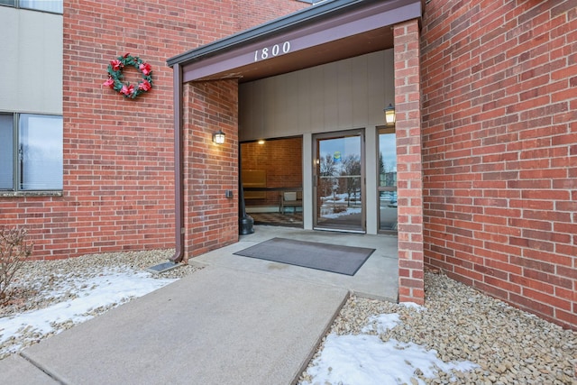 view of snow covered property entrance