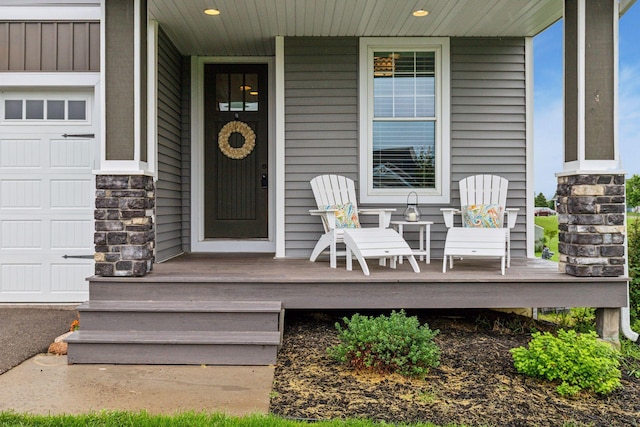 29135 Scenic Dr, Chisago City, MN 55013 - view of exterior entry featuring covered porch, stone siding, and a garage