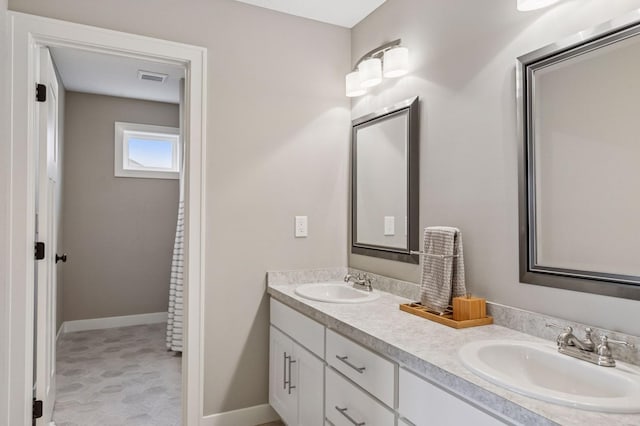 29135 Scenic Dr, Chisago City, MN 55013 - full bathroom featuring double vanity and baseboards
