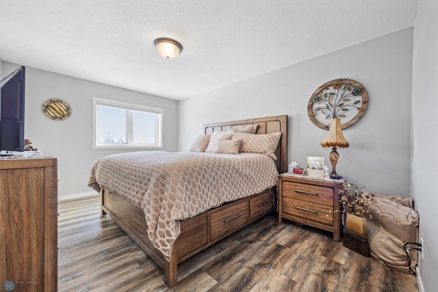 bedroom with dark hardwood / wood-style flooring and a textured ceiling