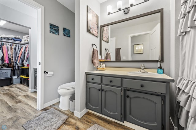 bathroom with vanity, hardwood / wood-style floors, and toilet