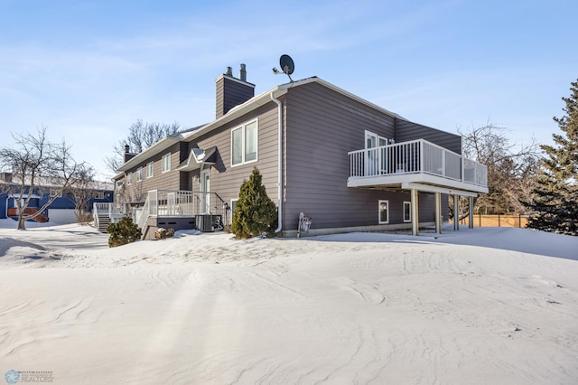 view of side of home with a wooden deck and central air condition unit