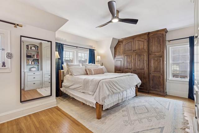 bedroom with ceiling fan and light hardwood / wood-style flooring