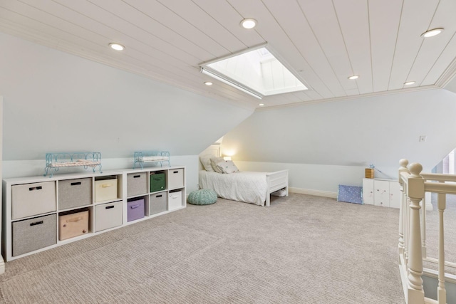 carpeted bedroom featuring lofted ceiling with skylight