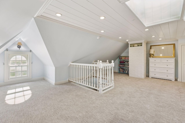 bonus room with light carpet and vaulted ceiling