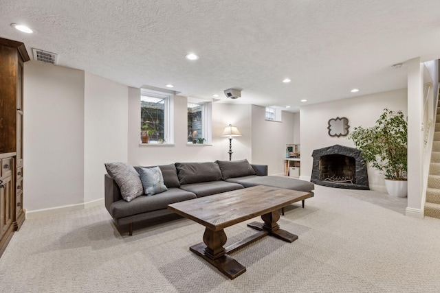 carpeted living room with a textured ceiling