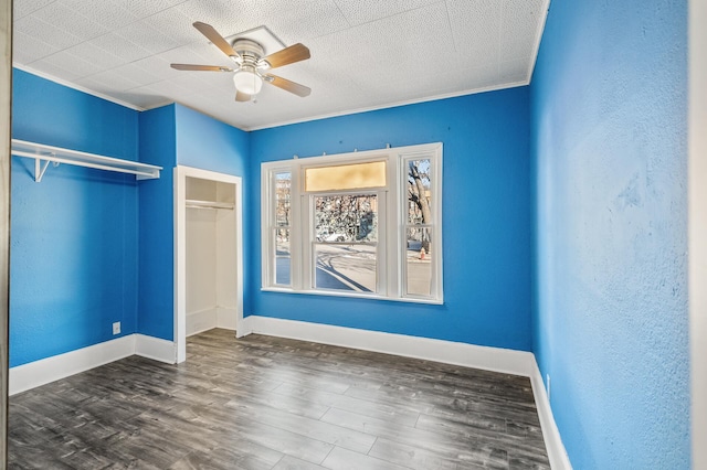 unfurnished bedroom with dark hardwood / wood-style floors and ceiling fan