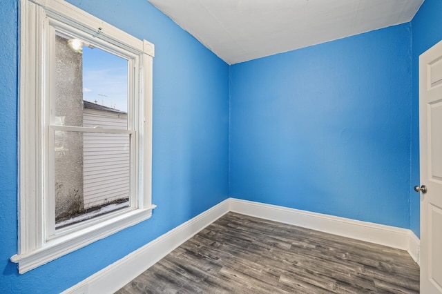 unfurnished room with wood-type flooring