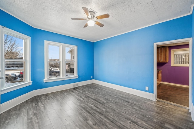 unfurnished room featuring ceiling fan, ornamental molding, and dark hardwood / wood-style floors