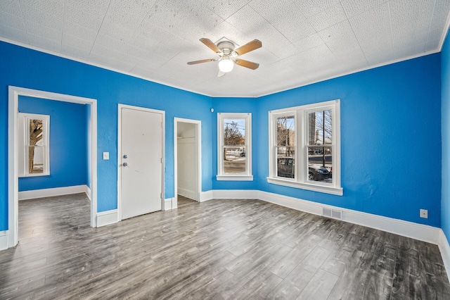 empty room featuring ceiling fan and hardwood / wood-style floors