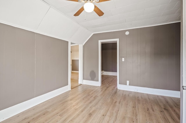 unfurnished room with vaulted ceiling, ceiling fan, and light hardwood / wood-style flooring