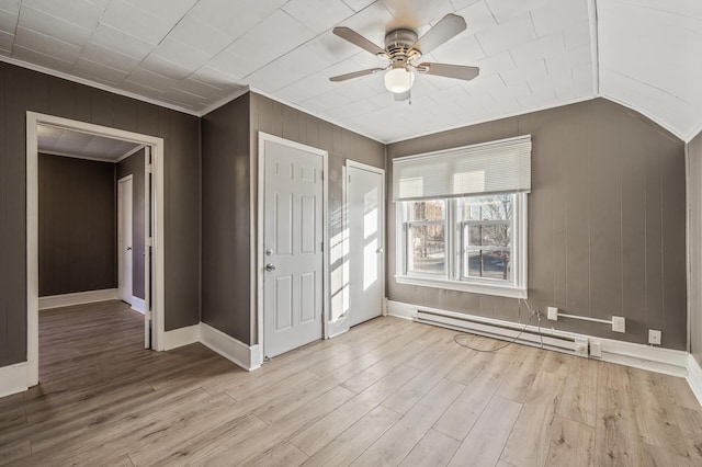 unfurnished bedroom with a baseboard radiator, ornamental molding, ceiling fan, and light wood-type flooring