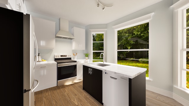 kitchen featuring stainless steel appliances, white cabinetry, a kitchen island, and wall chimney exhaust hood