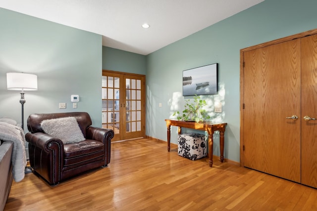 sitting room with light wood-type flooring and french doors