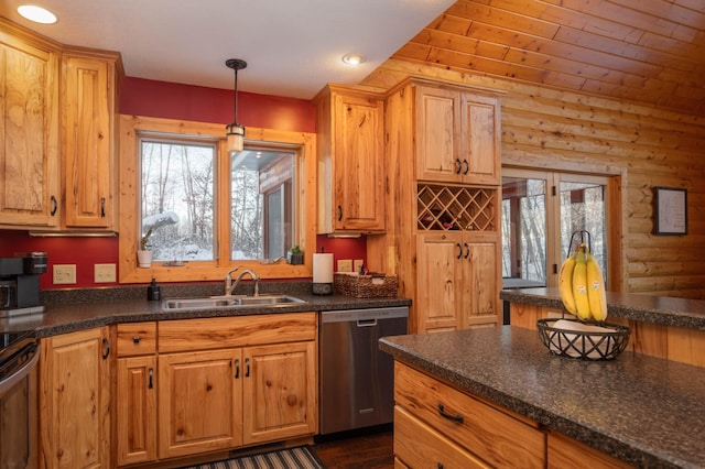 kitchen with appliances with stainless steel finishes, dark wood-type flooring, sink, hanging light fixtures, and rustic walls