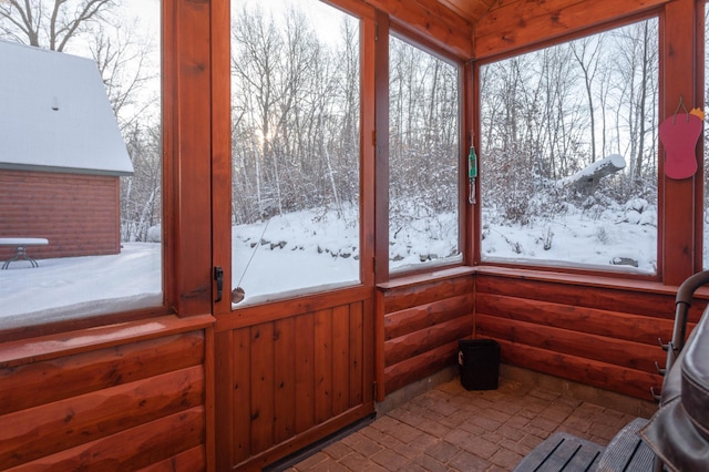 sunroom / solarium featuring a healthy amount of sunlight