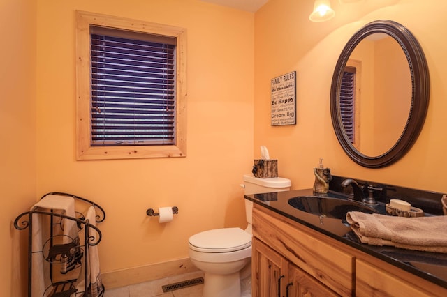 bathroom featuring toilet, tile patterned floors, and vanity