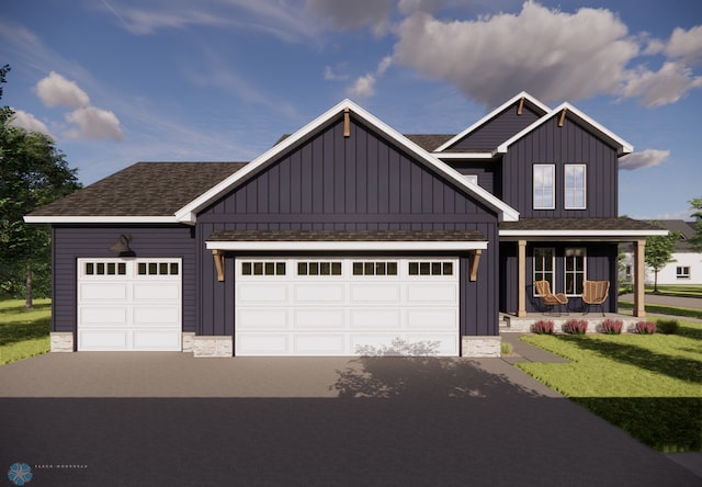 view of front of property featuring a front yard, covered porch, and a garage