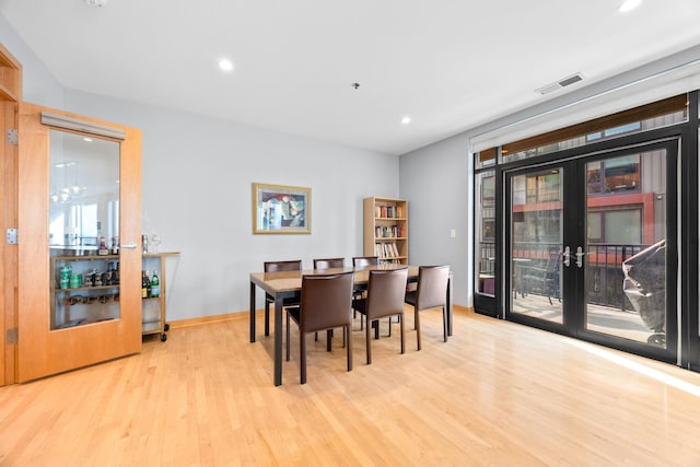 dining area featuring light hardwood / wood-style floors and french doors