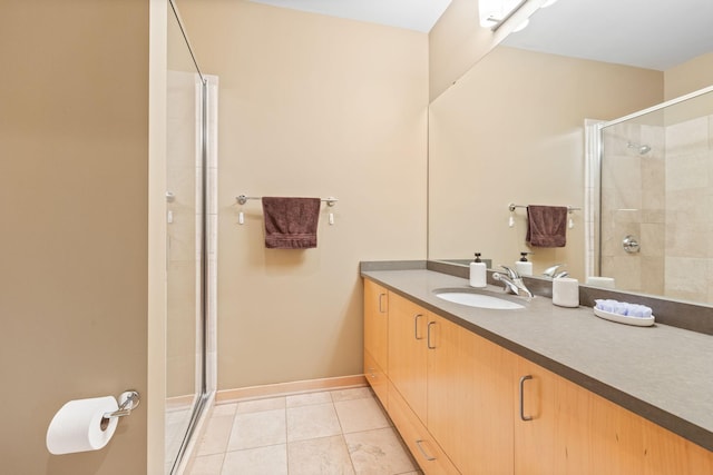 bathroom with vanity, tile patterned floors, and a shower with door