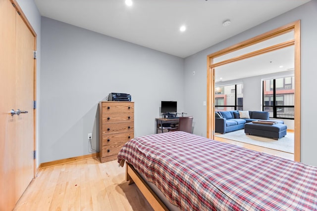 bedroom with a closet and light hardwood / wood-style floors