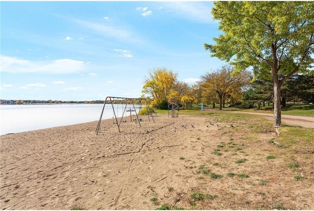 view of yard featuring a water view and a playground