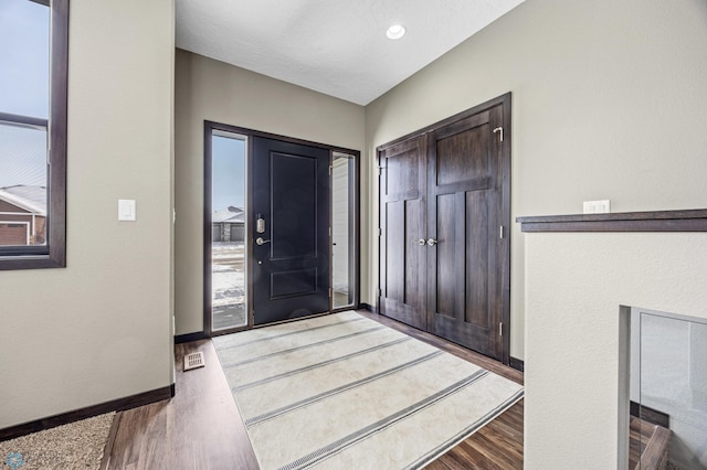 entryway featuring wood finished floors and baseboards