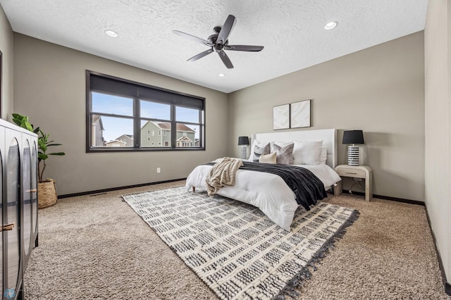 carpeted bedroom featuring a textured ceiling, baseboards, recessed lighting, and a ceiling fan