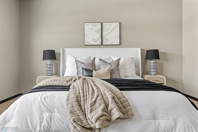 bedroom with baseboards and carpet
