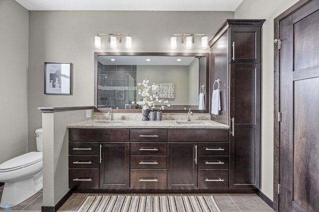 full bath with toilet, tile patterned flooring, a stall shower, and double vanity