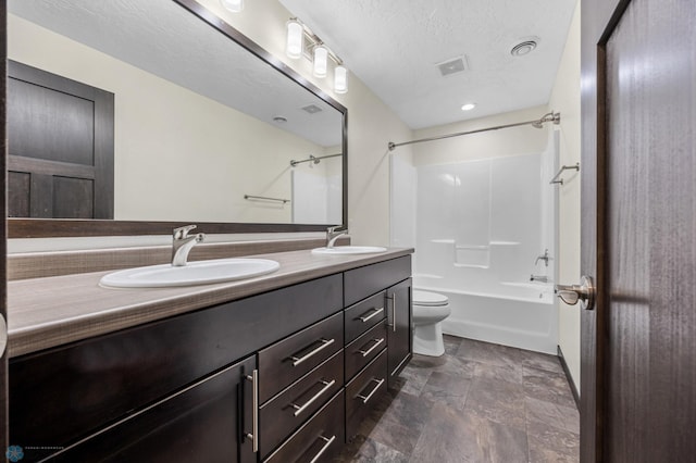full bath featuring shower / tub combination, toilet, double vanity, and stone finish flooring