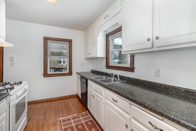 kitchen with white gas range, black dishwasher, sink, and white cabinets