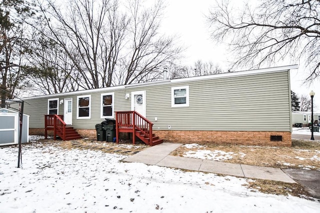 view of front of home with a shed