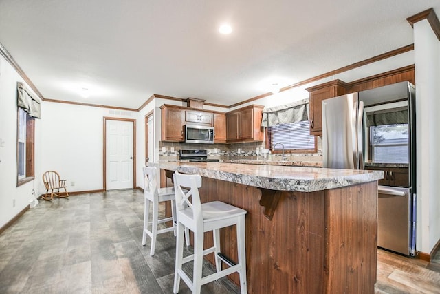 kitchen with sink, ornamental molding, tasteful backsplash, and stainless steel appliances