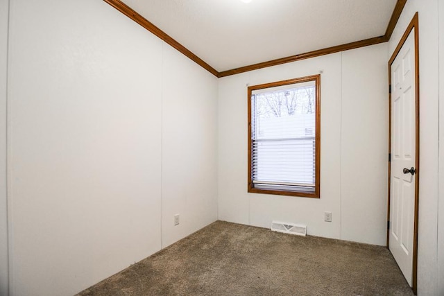 empty room featuring carpet flooring and ornamental molding