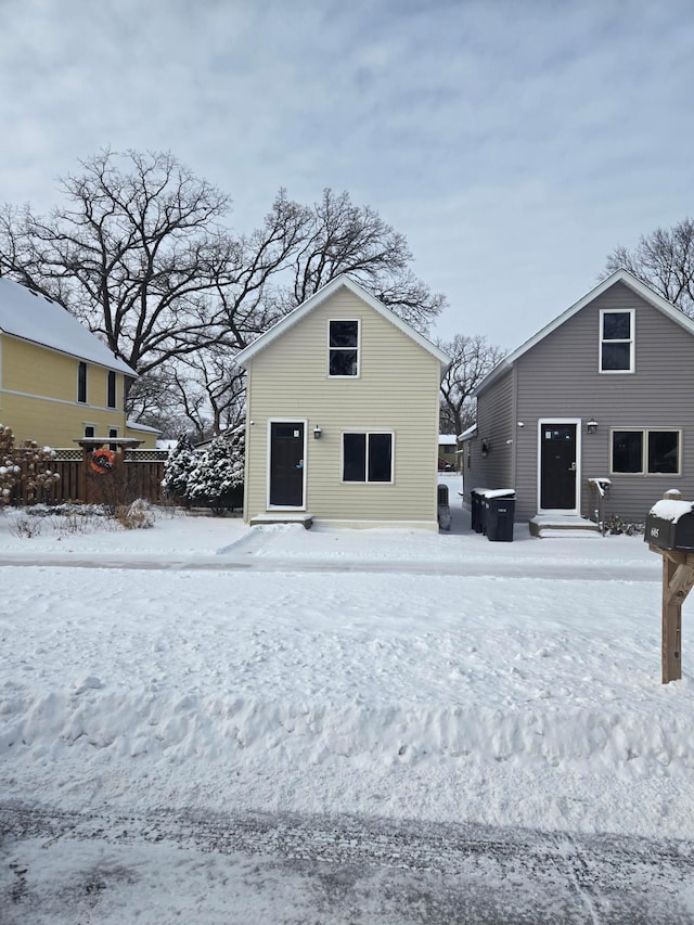 view of snow covered rear of property