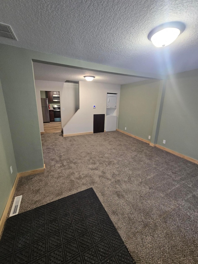 carpeted empty room with a textured ceiling