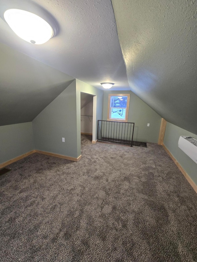 bonus room with carpet floors, a textured ceiling, and vaulted ceiling