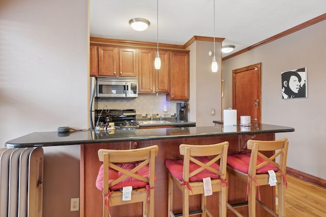 kitchen featuring range, a breakfast bar, and hanging light fixtures