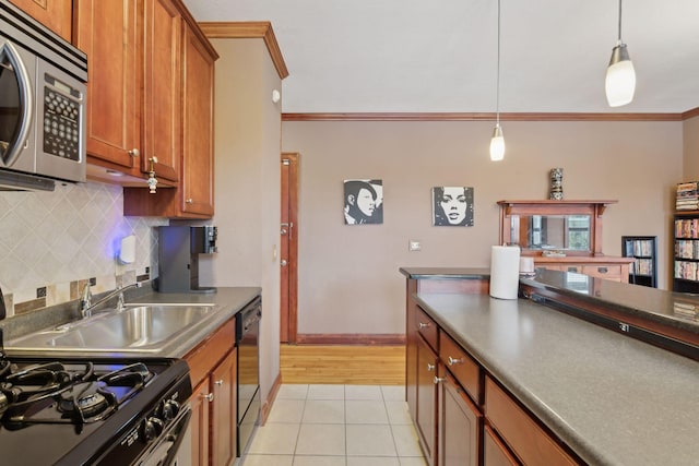 kitchen with light tile patterned floors, crown molding, dishwasher, gas range, and decorative light fixtures