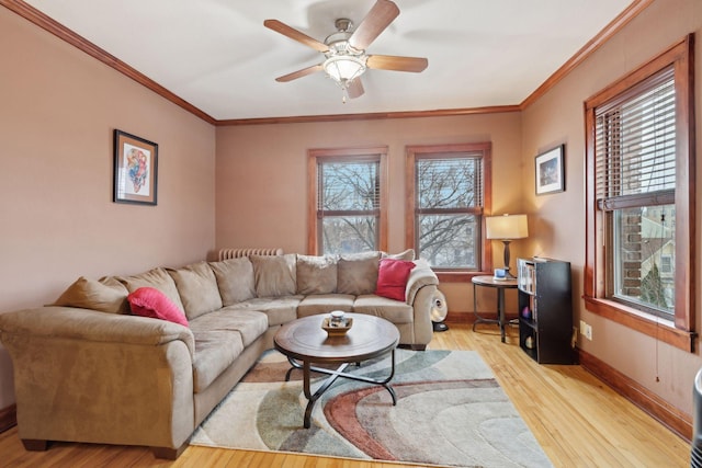 living room with ornamental molding, ceiling fan, and light hardwood / wood-style floors