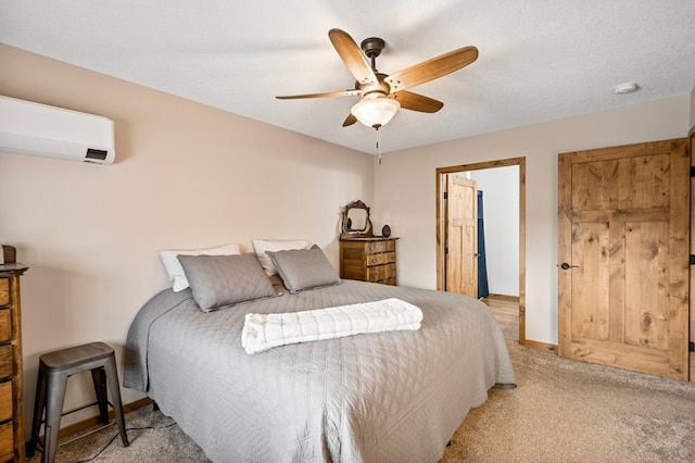 bedroom with light carpet, a wall mounted air conditioner, a textured ceiling, and ceiling fan