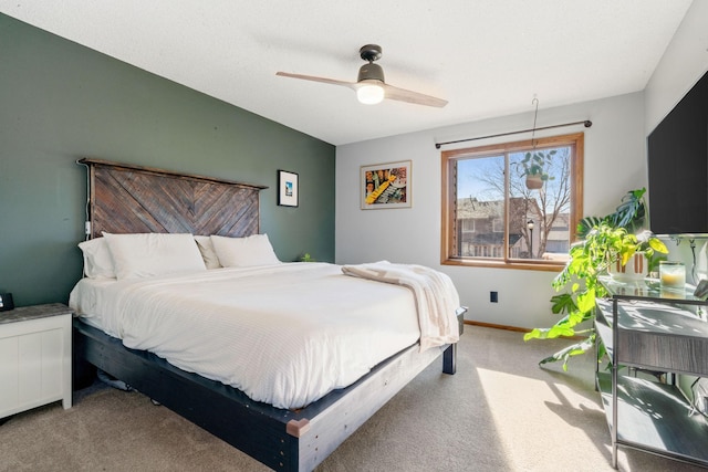 bedroom featuring baseboards and light colored carpet