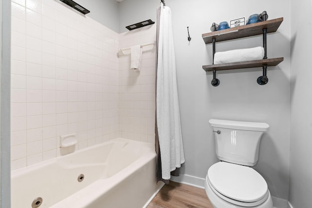 full bathroom featuring shower / tub combo, wood finished floors, toilet, and baseboards