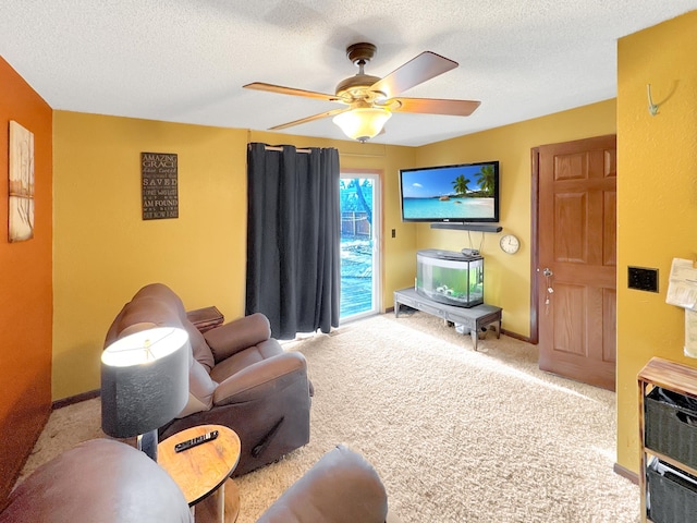 carpeted living room with ceiling fan and a textured ceiling