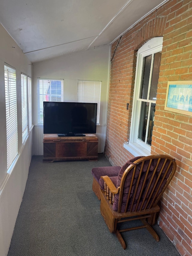 unfurnished sunroom featuring vaulted ceiling