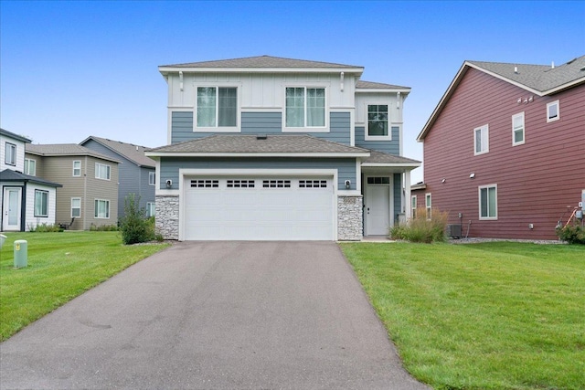 view of front of house with aphalt driveway, a garage, stone siding, a front lawn, and board and batten siding