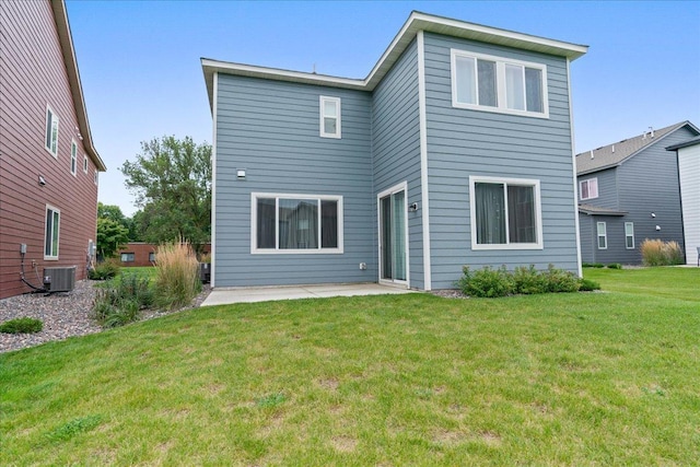 back of house with central air condition unit, a lawn, and a patio