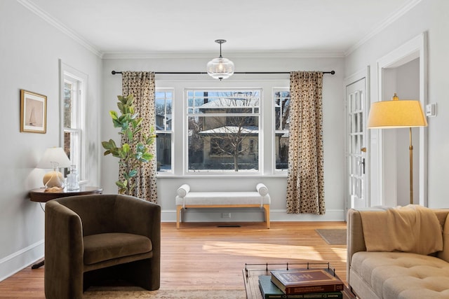 sitting room featuring ornamental molding and hardwood / wood-style floors